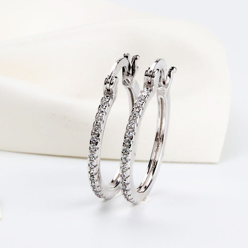 Large women's hoop earrings with zircon inlay, striking design
