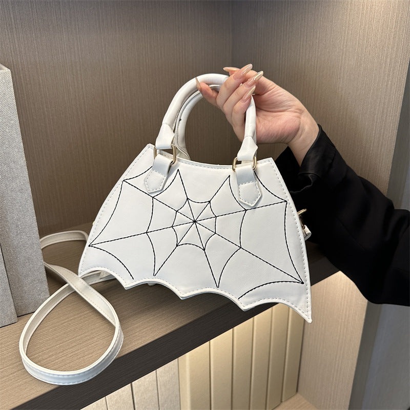 Fashionable Halloween saddle bag with spider web design, crossbody and shoulder bag with handle, women's handbag