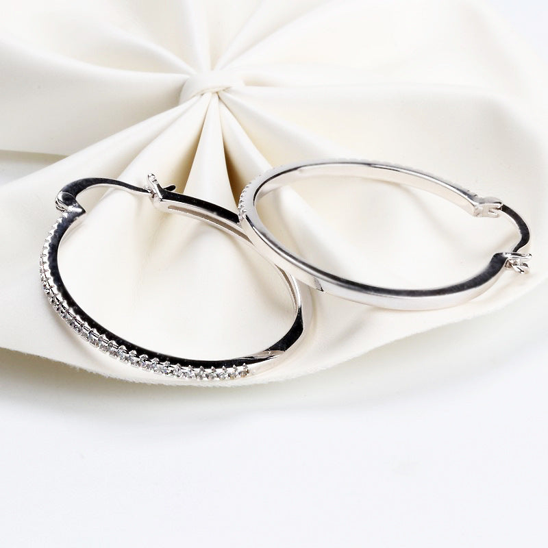 Large women's hoop earrings with zircon inlay, striking design