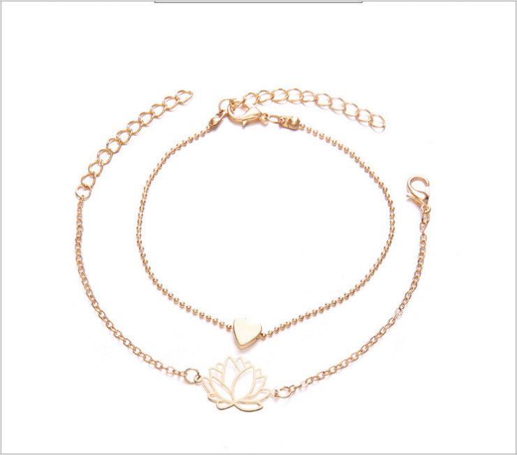 Vier­teiliges Armband-Set mit schwarzen Perlen, Herz-, Blatt- und Lotusmotiv