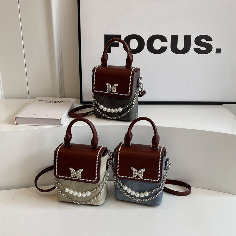 Simple women's crossbody mini bag in vertical format, portable, coin purse