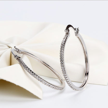 Large women's hoop earrings with zircon inlay, striking design