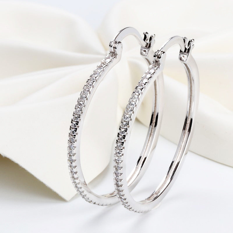 Large women's hoop earrings with zircon inlay, striking design