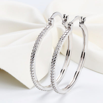 Large women's hoop earrings with zircon inlay, striking design