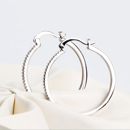 Large women's hoop earrings with zircon inlay, striking design